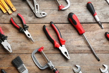 Flat lay composition with construction tools on wooden background