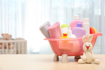 Wall Mural - baby cosmetic products, toys and towels on table indoors. space for text
