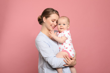 Canvas Print - Portrait of happy mother with her baby on color background