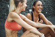 © Flamingo Images - Two laughing friends sitting outside after a run together