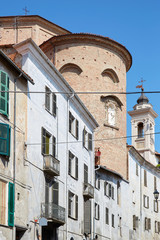 Wall Mural - Misericordia church back part in red bricks and old buildings in a sunny summer day, blue sky in Mondovi, Italy.