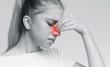 Sad woman holding her nose because sinus pain