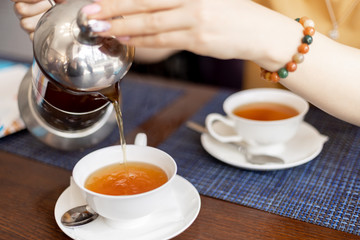 girl pours tea