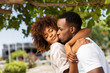 Outdoor protrait of black african american couple kissing each other