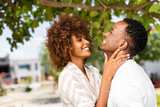 Fototapeta Miasto - Outdoor protrait of black african american couple kissing each other