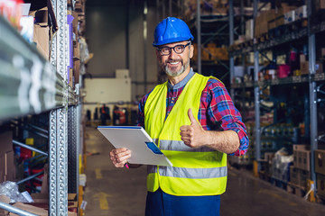 Wall Mural - Warehouse worker with clipboard in warehouse