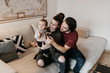 © Westend61 - Happy family with baby girl in living room at home