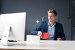 © Westend61 - Young businessman sitting at desk in office playing table tennis