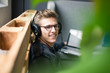 © Westend61 - Smiling young man listening to music with headphones