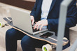 © Westend61 - Young businessman with skateboard sitting outdoors on stairs using laptop
