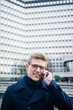 © Westend61 - Portrait of smiling young man talking on cell phone in the city