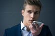 © Westend61 - Portrait of young businessman using smartphone