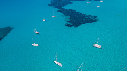 Wall Mural - Amazing drone aerial landscape of the charming area of Es Trencs and the boats with a turquoise sea. It has earned the reputation of Caribbean beach of Mallorca. Spain