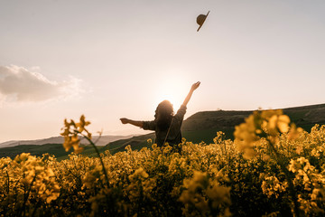 back view of happy woman in the countryside