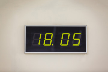 Black digital clock on a white background showing time 18.05