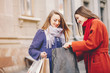 © hetmanstock2 - two beautiful and stylish girlfriends walking around the spring city with packages and shopping