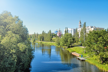 Wall Mural - Tambov old city in russia historic scenic skyline panorama landscape view of river park embankment ancient modern architecture building famous russian orthodox church domes against blue sky background