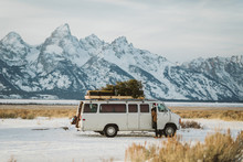 White Van With Christmas Tree Parked Beneath The Tetons