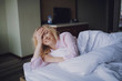 © Cavan Images - Beautiful woman relaxing on a bed