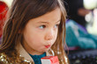 © Cavan Images - a cute little girl sips juice from a straw