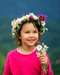 Wall Mural - cute girl with flower crown smiling and having fun on meadow