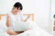 © NT_studio - Beautiful of portrait asian young woman sitting relax and leisure with laptop computer internet online on bed in bedroom, cheerful of asia girl with gesture glad and success, lifestyle concept.