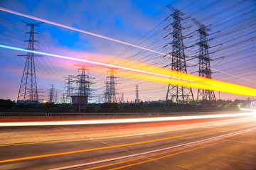 High voltage, high speed road car track in the background of high voltage towers