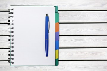 Poster - Open blank notebook and pen on a white background