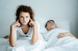 Caucasian Couple on bed with white mattress Man snoring loud makes women feel annoyed. Causes Obstructive Sleep Apnea Stroke Chronic depression Sexual dysfunction It can be  cause of divorce spouse.