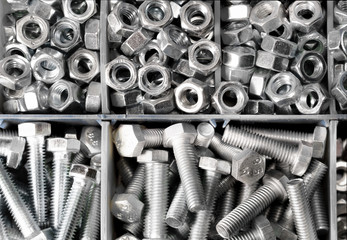 new bolts and nuts sorted in container shot closeup, background, repair concept