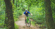 Man mountain bikes in forest