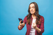 © denis_vermenko - Portrait of a furious young business woman yelling at mobile phone isolated over blue background.