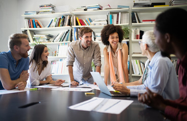 Cheerful coworkers in office during company meeting