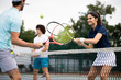 © NDABCREATIVITY - Fit happy poeple playing tennis together. Sport concept
