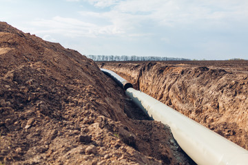 Wall Mural - Industrial gas pipeline. Laying new pipes in field underground