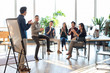 © Blue Jean Images - Young abroad students applauding in seminar