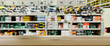 Shop for selling electric tools. Drills, screwdrivers, electric saws, grinder. Defocused, blurred image. In the foreground is the top of a wooden table, counter.