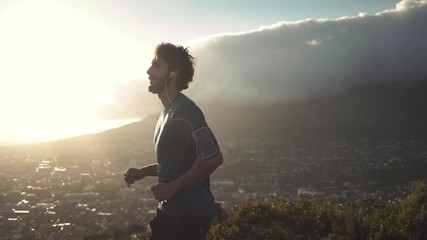 Wall Mural - Morning jogger moves hands running up valley hill