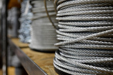 Clean New Steel Cable, Steel Wire Or Steel Rope Wound On A Bobbins Standing On A Shelf