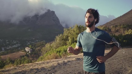 Wall Mural - Young male athlete running in slow motion