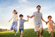 © Blue Jean Images - Happy young family running on meadow