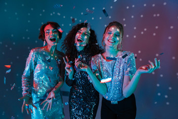 Wall Mural - Happy Three beauty women wearing in shiny clothes