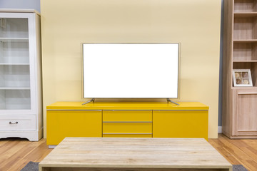 Wall Mural - LED TV is located on the table in the living room of the house with a white screen in front view- Image.