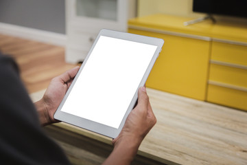 Wall Mural - Mockup tablet on businessman hands empty display on home table with blur background. - Image - Image