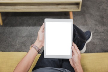 Wall Mural - Mockup tablet on businessman hands empty display on home table with blur background. - Image - Image