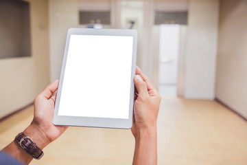 Wall Mural - Mockup tablet on businessman hands empty display on home table with blur background. - Image - Image