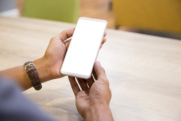 Wall Mural - Mockup smartphone on businessman hands empty display on home table with blur background. - Image - Image