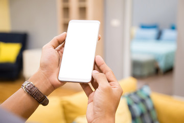 Wall Mural - Mockup smartphone on businessman hands empty display on home table with blur background. - Image - Image