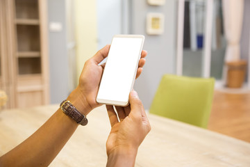 Wall Mural - Mockup smartphone on businessman hands empty display on home table with blur background. - Image - Image