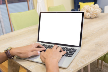 Wall Mural - Mockup image of a businessman using laptop with blank white desktop screen working in home- Image